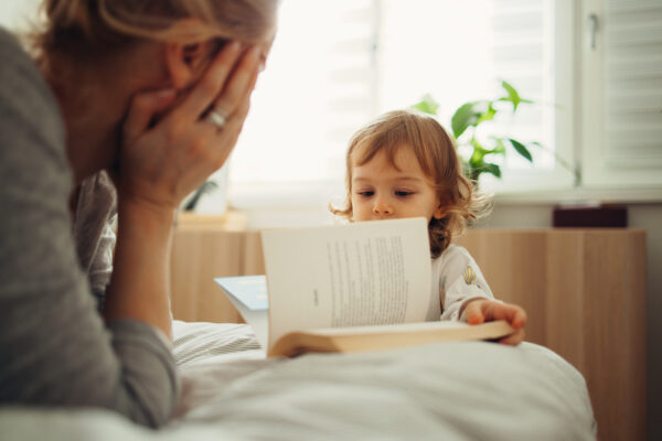 Mother and Daughter Looking at the Book in the Morning